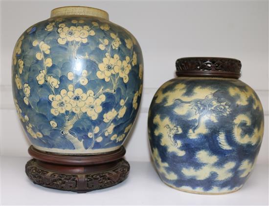 Two Chinese blue and white ovoid jars, 19th century, largest 23cm, carved wood stands and cover